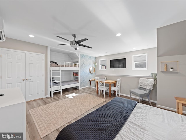 bedroom with ceiling fan, a closet, and light hardwood / wood-style floors