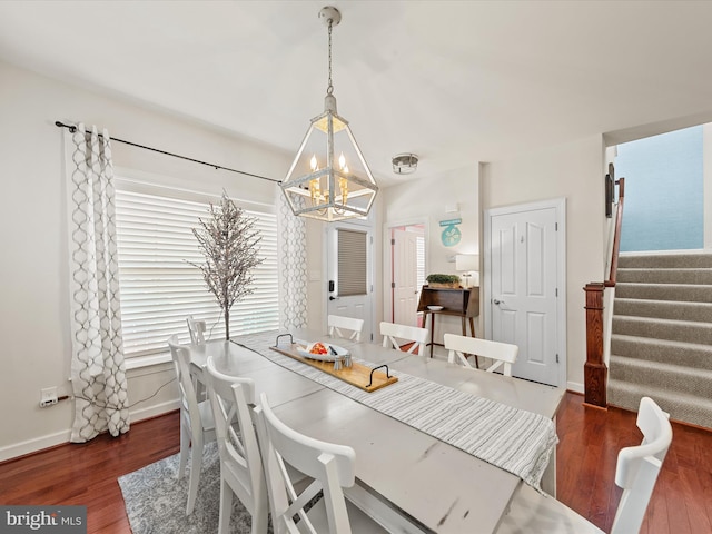 dining room featuring dark hardwood / wood-style floors and a notable chandelier