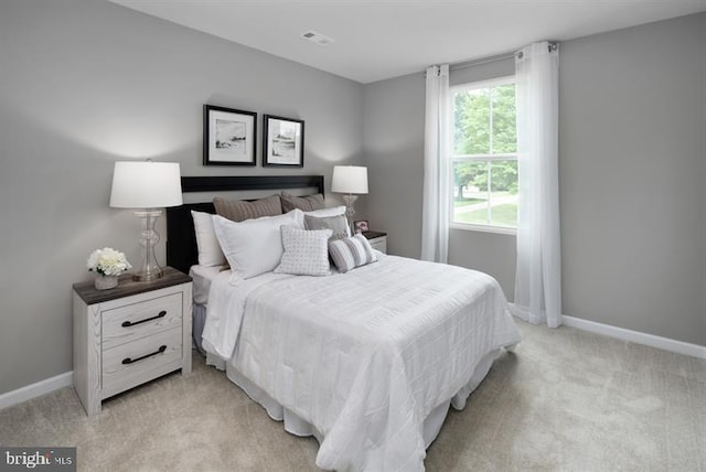 bedroom with light colored carpet