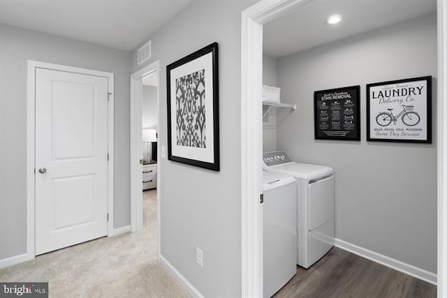 laundry area with wood-type flooring and independent washer and dryer