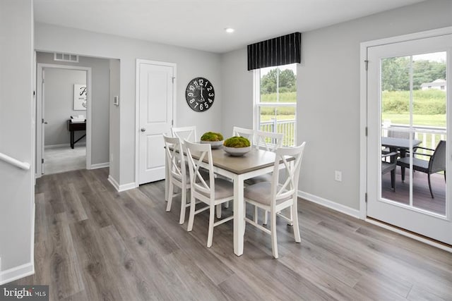 dining space featuring wood-type flooring