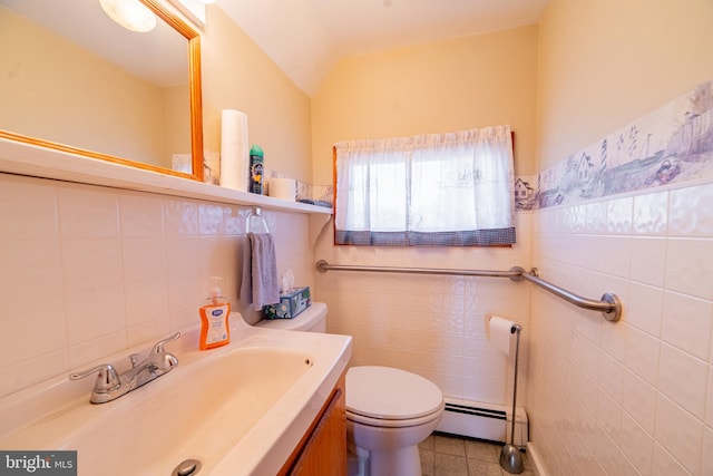 bathroom with lofted ceiling, tile patterned flooring, a baseboard radiator, and tile walls