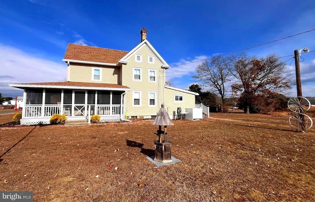 back of house with a sunroom