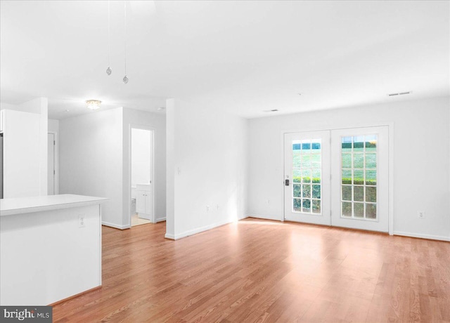 unfurnished living room with light wood-type flooring