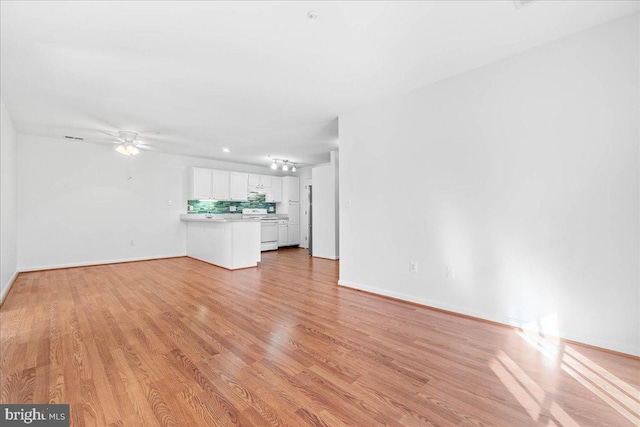 unfurnished living room with ceiling fan and light wood-type flooring