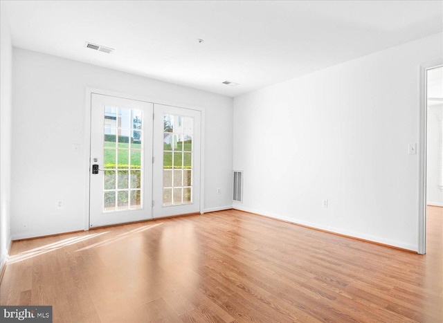 spare room featuring light hardwood / wood-style floors