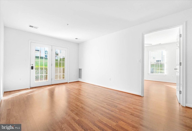 spare room with light hardwood / wood-style flooring