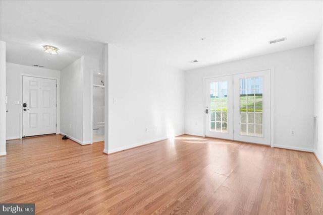 spare room with light hardwood / wood-style floors