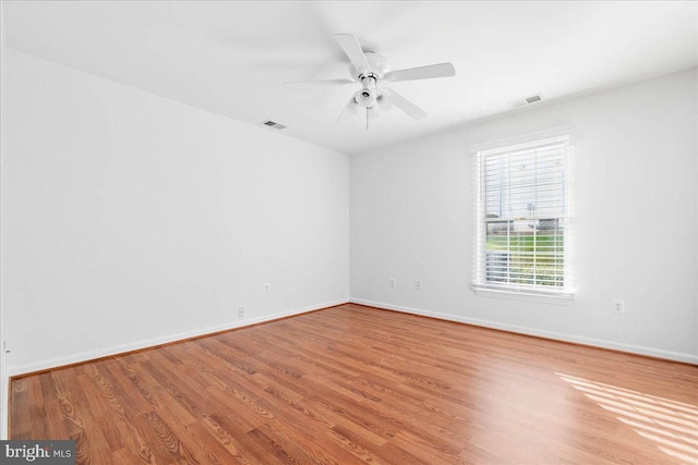 empty room with hardwood / wood-style flooring and ceiling fan