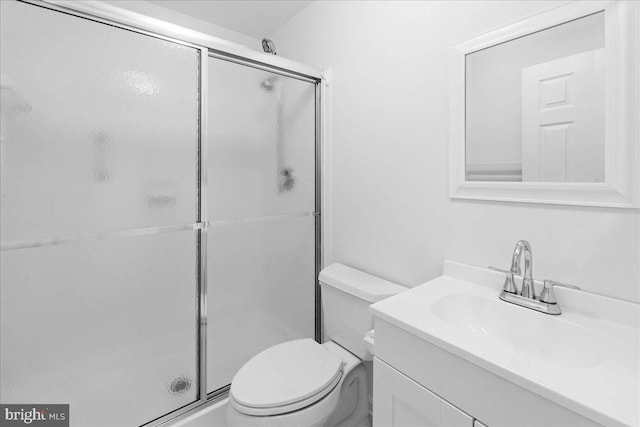 bathroom featuring vanity, toilet, and an enclosed shower