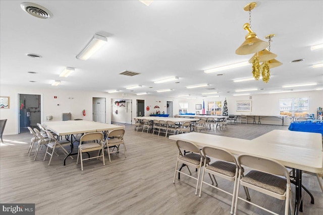 dining space with hardwood / wood-style flooring