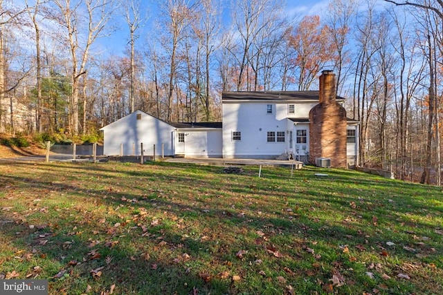 rear view of property featuring a lawn, a patio area, and central air condition unit