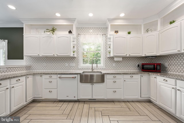 kitchen with sink, light stone counters, crown molding, decorative backsplash, and white cabinets