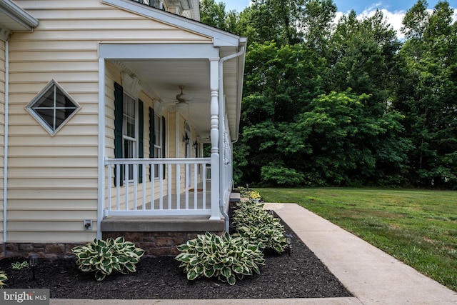 exterior space featuring a lawn, ceiling fan, and a porch