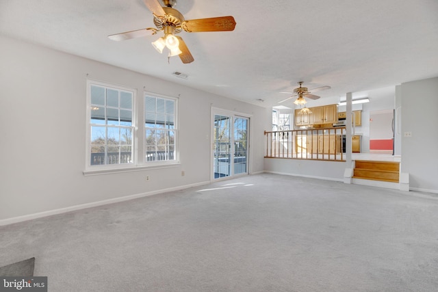 unfurnished living room featuring ceiling fan and light carpet