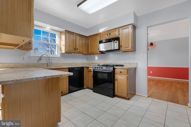 kitchen with black appliances, light tile patterned flooring, and kitchen peninsula