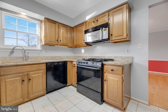 kitchen featuring light tile patterned floors, sink, light stone counters, and black appliances