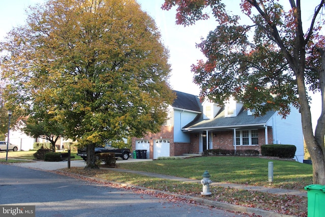 view of front of house with a garage and a front lawn