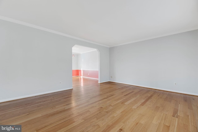 spare room with light hardwood / wood-style floors and ornamental molding