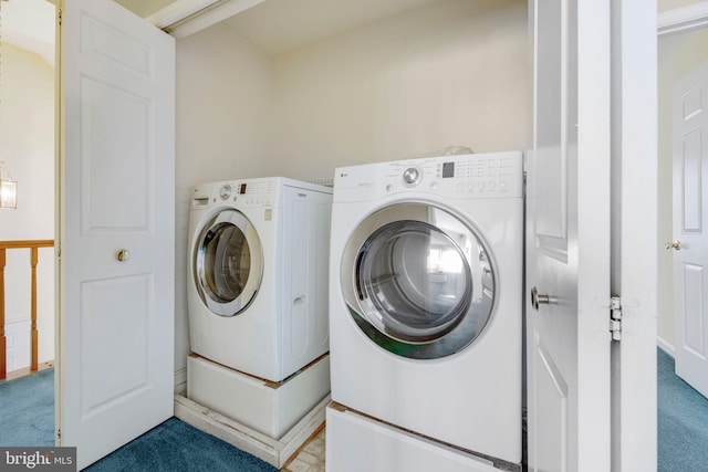 laundry room featuring carpet flooring and washing machine and dryer