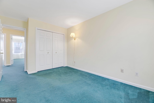 unfurnished bedroom with a closet and dark colored carpet