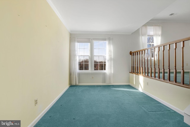 unfurnished room featuring carpet flooring, ornamental molding, and a healthy amount of sunlight