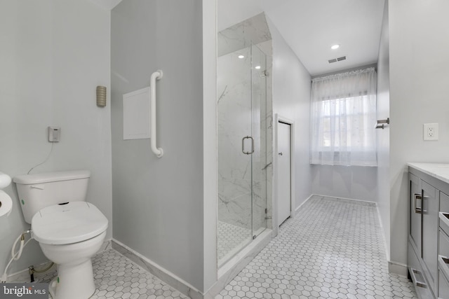 bathroom with tile patterned flooring, vanity, toilet, and a shower with shower door