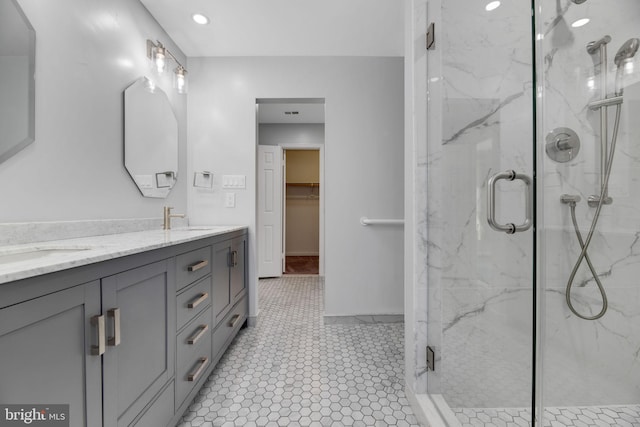 bathroom featuring tile patterned flooring, vanity, and an enclosed shower