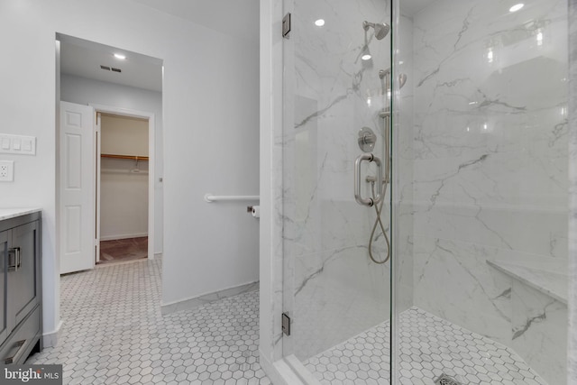 bathroom featuring tile patterned floors, vanity, and an enclosed shower