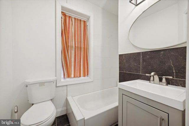 bathroom with backsplash, a washtub, vanity, tile patterned flooring, and toilet