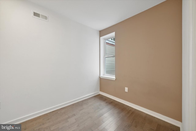 spare room with hardwood / wood-style floors