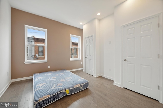 bedroom featuring light hardwood / wood-style flooring and multiple windows