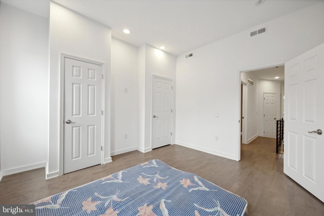 bedroom with a closet and dark wood-type flooring