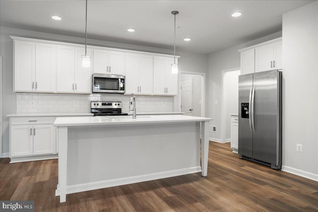 kitchen featuring pendant lighting, white cabinetry, dark wood-type flooring, and appliances with stainless steel finishes