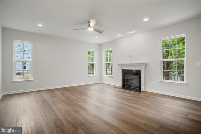 unfurnished living room with hardwood / wood-style floors and ceiling fan