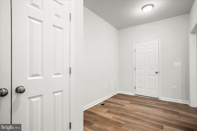 corridor featuring hardwood / wood-style floors