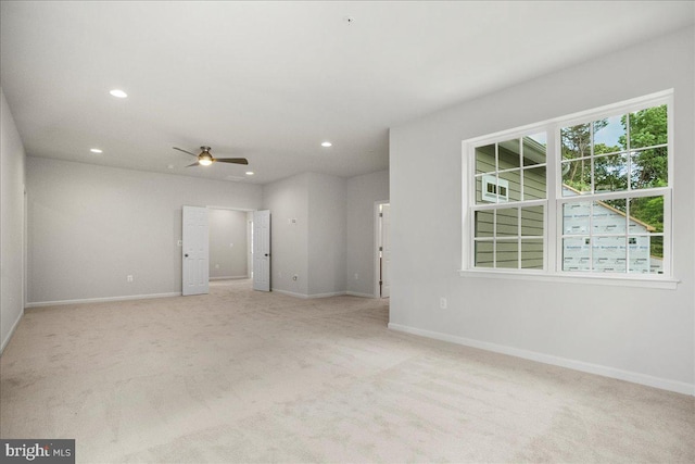 carpeted spare room featuring ceiling fan