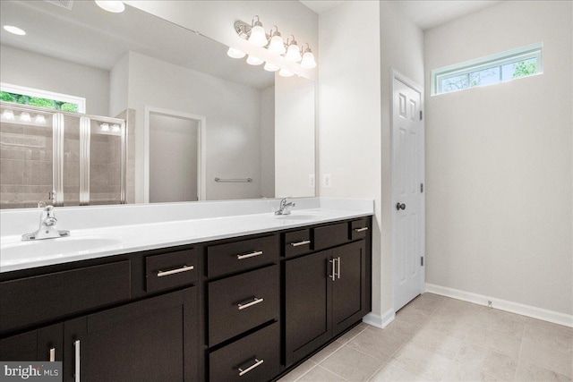 bathroom with vanity and a shower with door