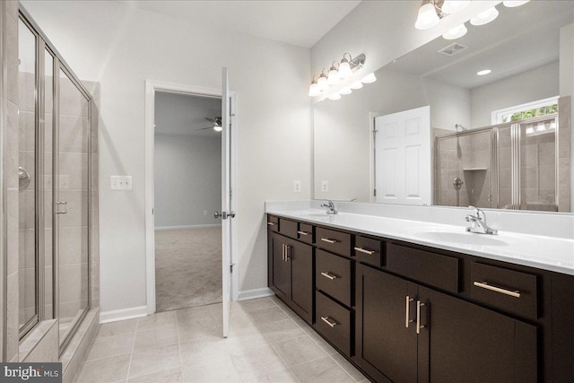 bathroom featuring tile patterned floors, ceiling fan, a shower with door, and vanity