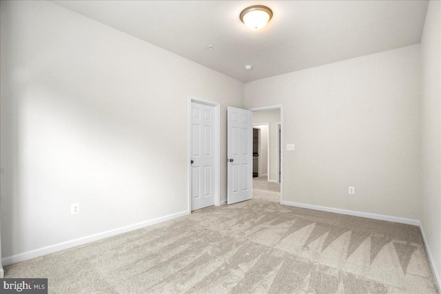 unfurnished bedroom with light colored carpet