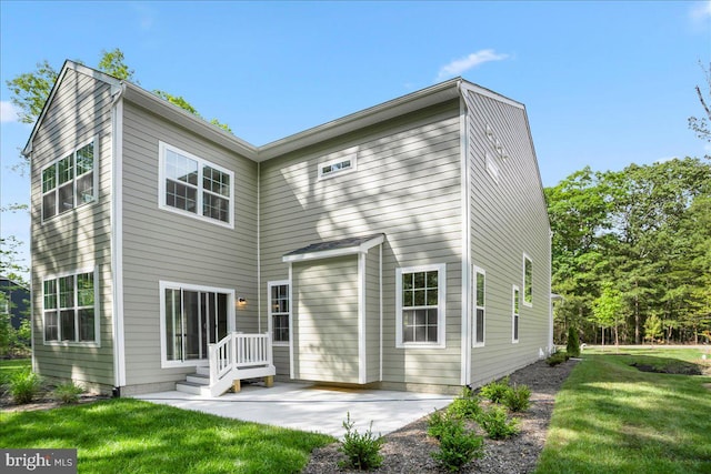 back of property featuring a yard and a patio