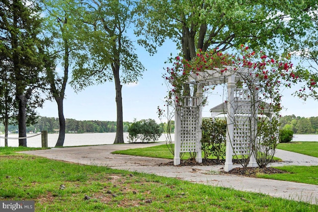 surrounding community featuring a yard and a water view