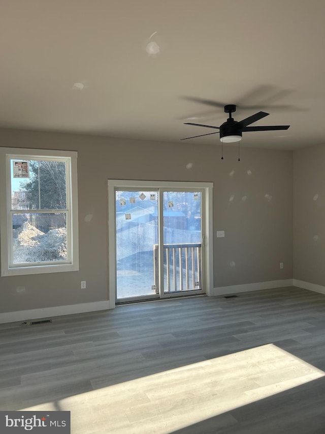 spare room featuring dark wood-type flooring and ceiling fan