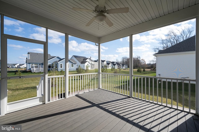 sunroom with ceiling fan and wood ceiling