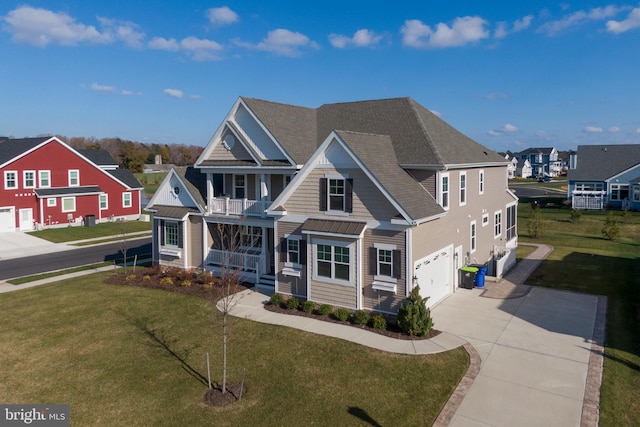 view of front of home with a porch, a garage, a balcony, and a front lawn