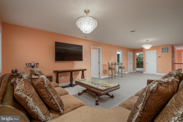 living room featuring carpet and an inviting chandelier