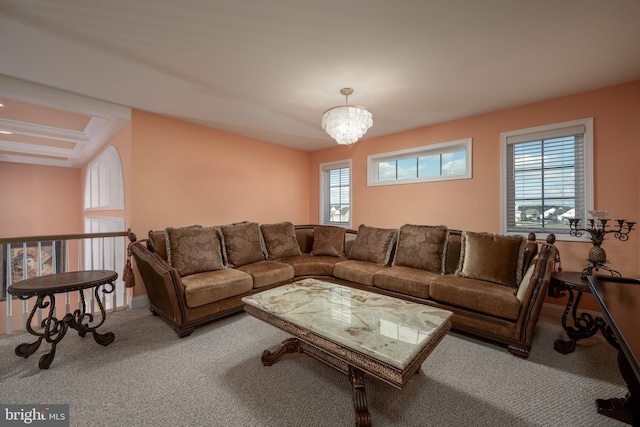 living room with light carpet, a wealth of natural light, and an inviting chandelier