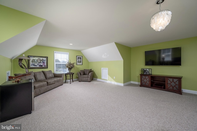 carpeted living room featuring vaulted ceiling and a notable chandelier