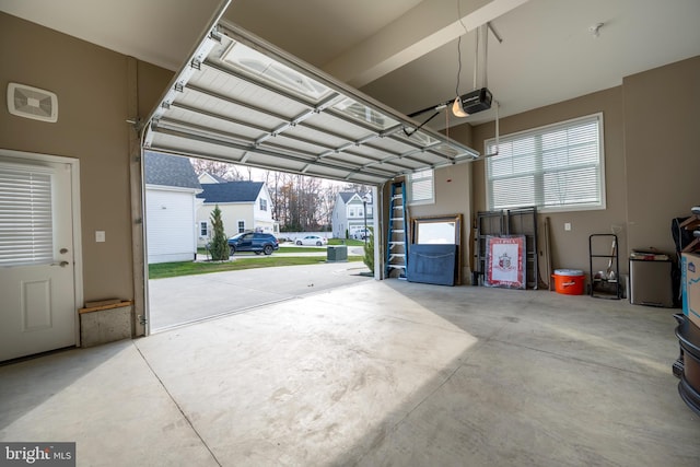 garage featuring a garage door opener and a carport