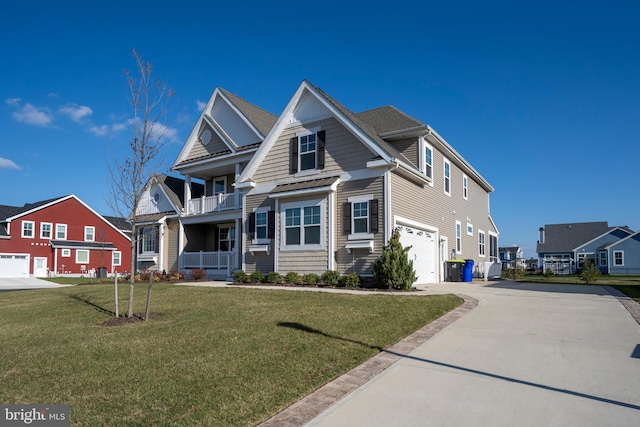 view of front of home with a garage, a balcony, and a front lawn